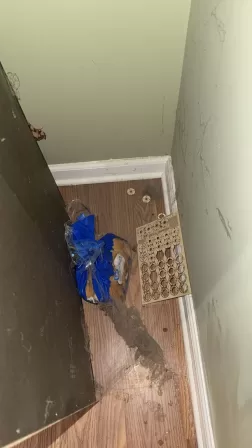 Dirty wall behind furniture showing dust and grime accumulation before deep cleaning