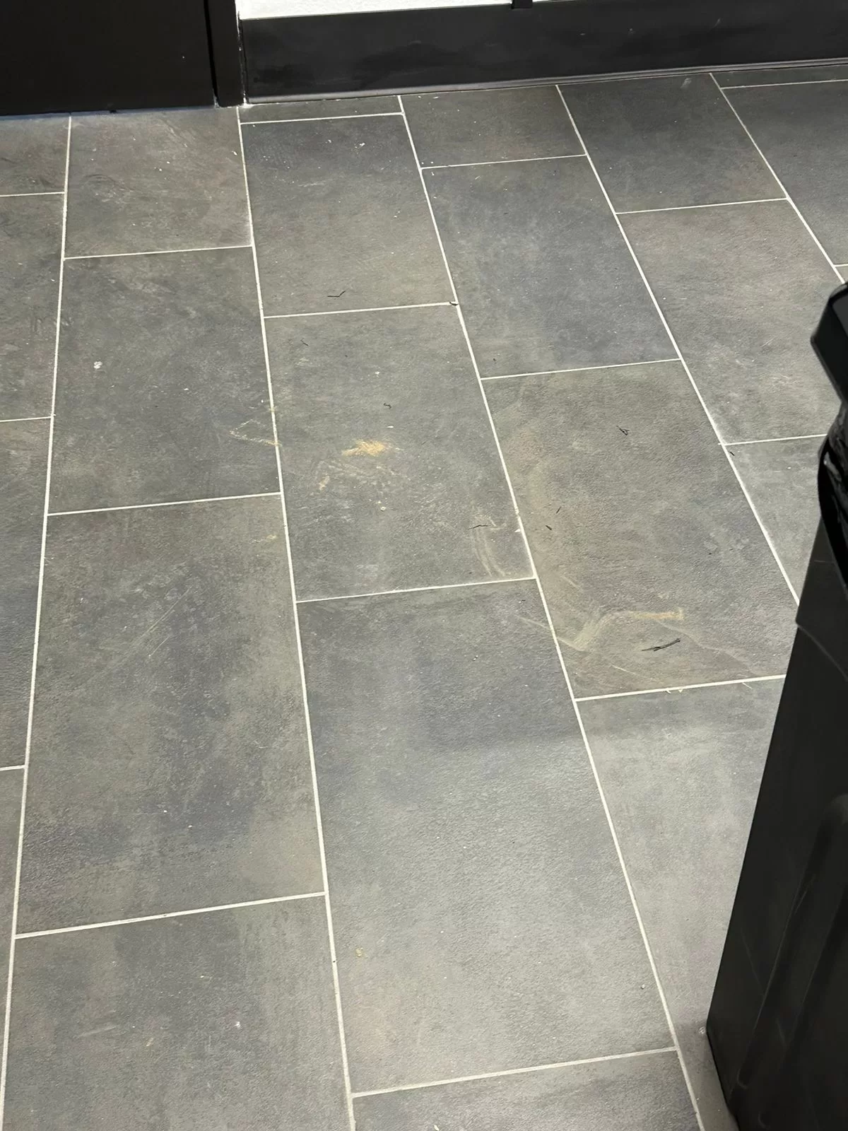 Commercial floors before professional deep cleaning - covered in construction debris