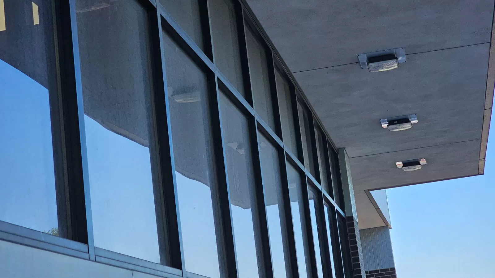 Commercial windows before professional cleaning - showing construction dust and debris