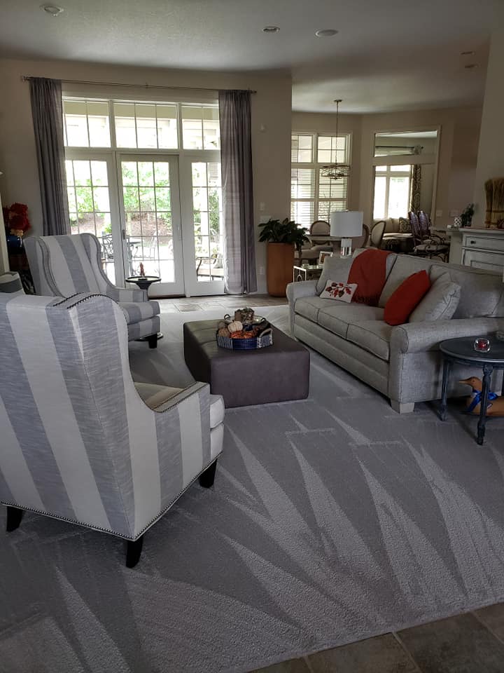 Professional recurring cleaning results - living room with visible vacuum lines showing attention to detail