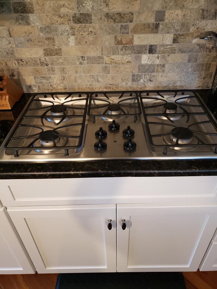 Professional stove and appliance cleaning results showing pristine gas stove in Dayton OH kitchen